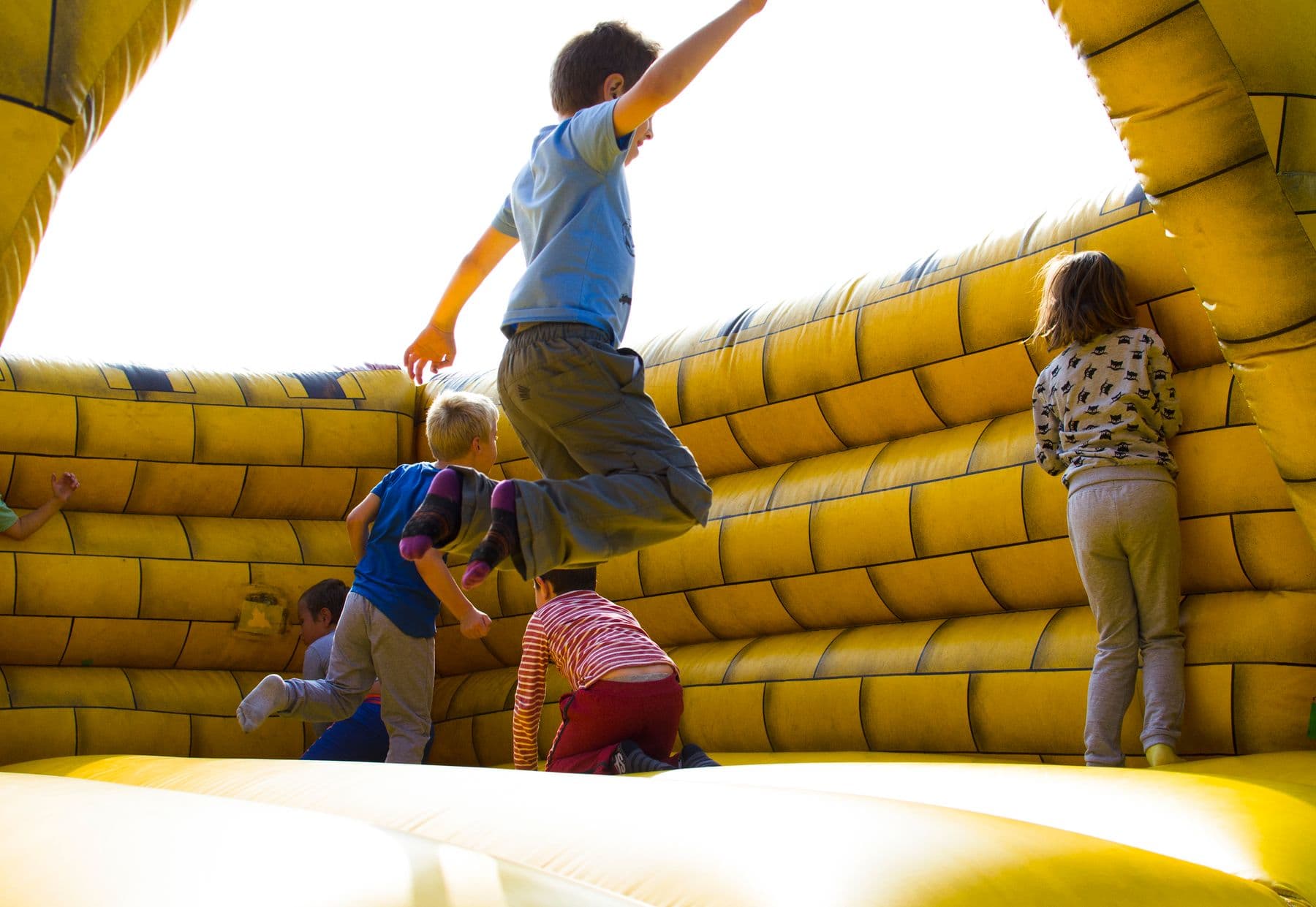 Children playing together inside an inflatable bounce house